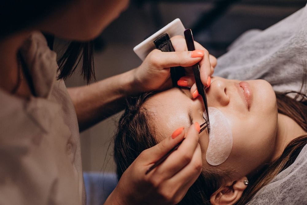 Eyelash extension application by a lash artist at Rejuvia Beauty & Aesthetics salon, Stratford Cairns